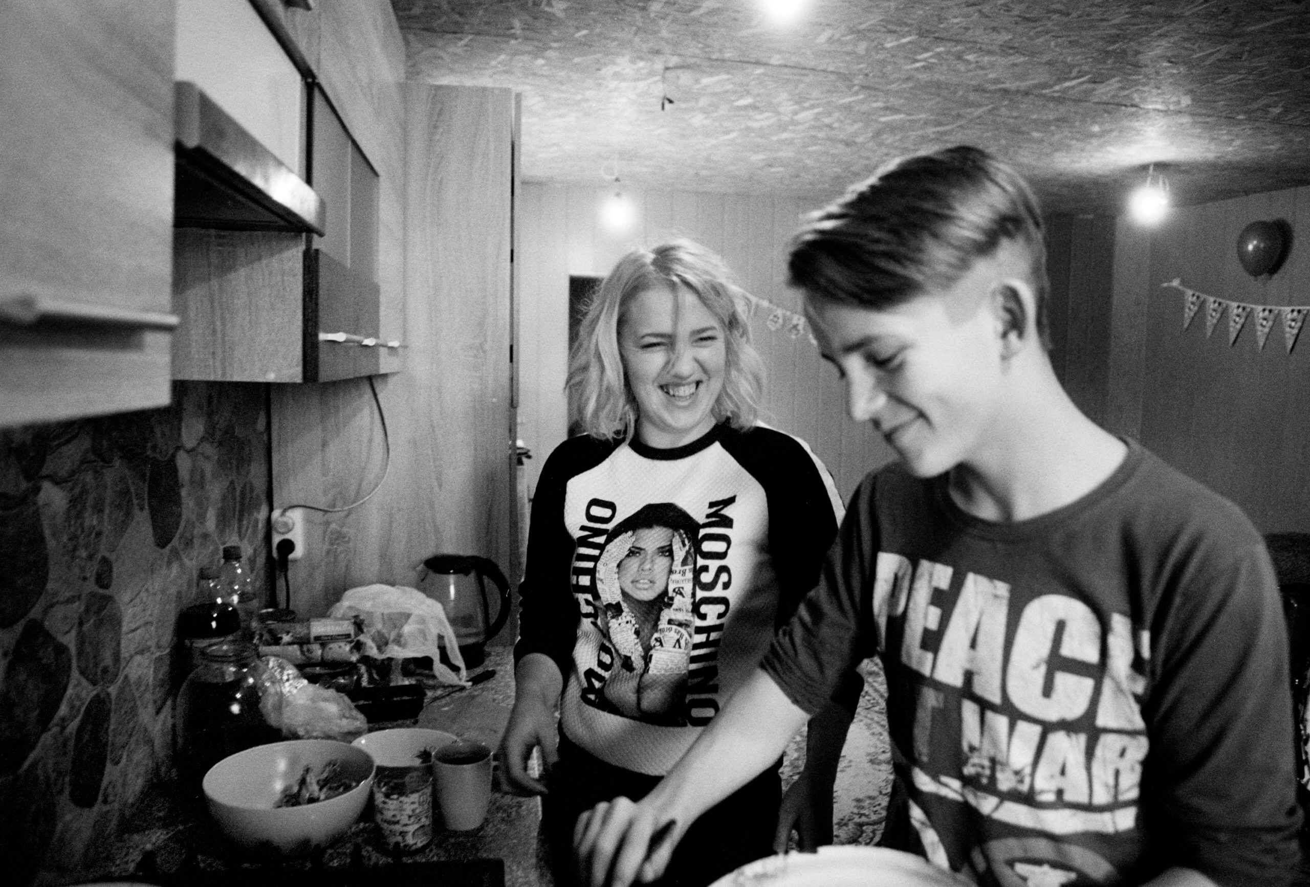 Teenage boy making dinner with his mum
